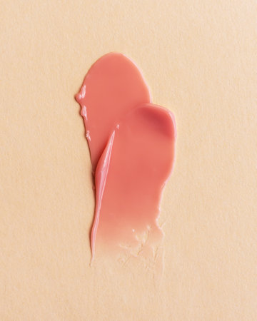 Coral pattern cosmetic smear texture on beige backgroundの写真素材