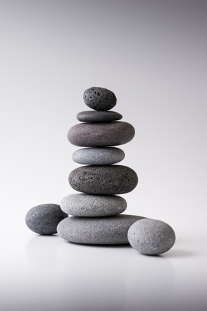 Balancing pebble stones on gray background. Relax, meditation and zen concept.の写真素材