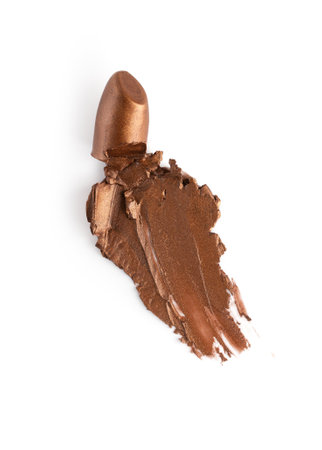 Lipstick smear smudge isolated on white background. Shiny golden color cosmetic product brush sample.の写真素材