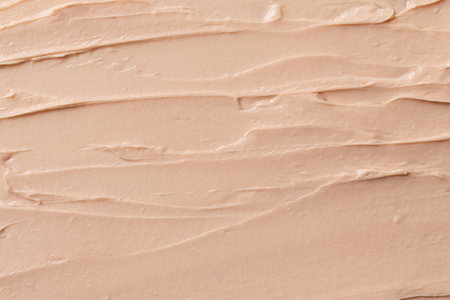 Beige smeared texture of tonal face cream. Cosmetics products for makeup and skin care.の写真素材
