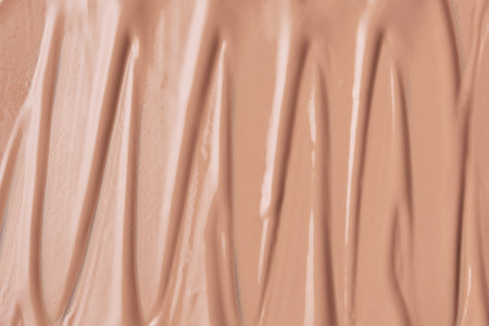 Delicate beige smeared texture of BB face cream, tonal foundation is smudged. Cosmetics products for makeup and skin care.の写真素材