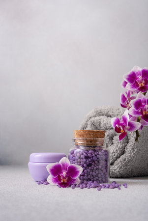 Bath products for wellness and spa with purple orchid flowers. Toiletries for bodycare and selfcare.の写真素材
