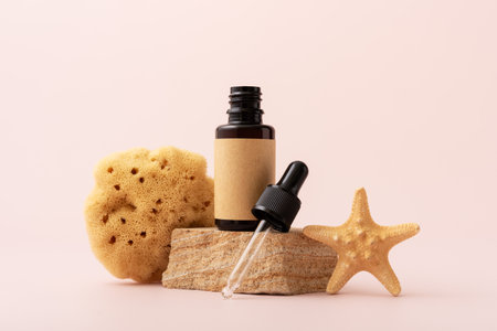 Brown glass serum bottle for organic cosmetic with sea minerals. Mock-up for skincare cosmetic product and sea shells.の写真素材