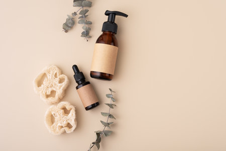 Eco-friendly skincare accessories concept with loofah sponges, cosmetic glass bottles and eucalyptus. Zero waste spa and bath products for sustainable life style.の写真素材