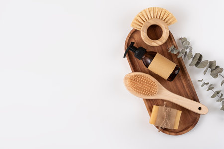 Set of personal care items on a wooden tray, including soap bar, clean brush and reusable bottles. Zero waste sustainable lifestyle concept. Eco friendly wellness and self care.の写真素材