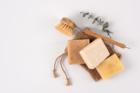 Handcraft organic soap bars with cleaning brush and washcloth, top view. Healthy lifestyle and...