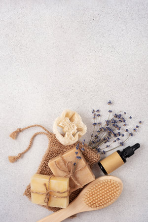Handcrafted soap bars, sisal washcloth, wooden massage brush and lavender flowers. Set for eco friendly bathroom and bodycare concept.の写真素材