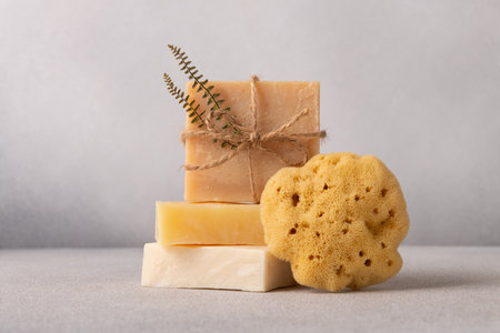 Stack of handcrafted soap bars and natural sea sponge. Natural, organic cleaning and bath concept.の写真素材