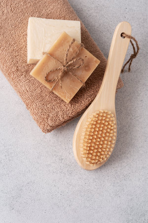 Handmade soap bars, terry towel and wooden massage brush. Bodycare and wellness concept.の写真素材