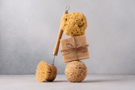 Natural handmade soap bar on sphere stone podium with natural sea sponge and bamboo brush. Organic and sustainable bathroom lifestyle concept.の写真素材