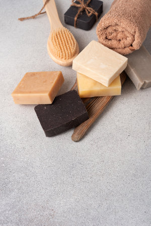 Handmade soap bars, terry towel and wooden massage brush. Bodycare and wellness concept.の写真素材