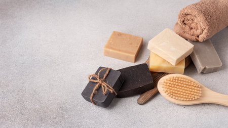 Handmade soap bars, terry towel and wooden massage brush. Bodycare and wellness concept.の写真素材