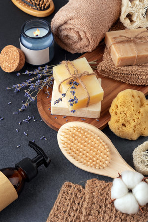 A cozy spa setup featuring handmade soap, lavender sprigs, a wooden brush, and a lit candle. Perfect for self-care, skincare routines, and creating a calming, natural bath atmosphere.の写真素材