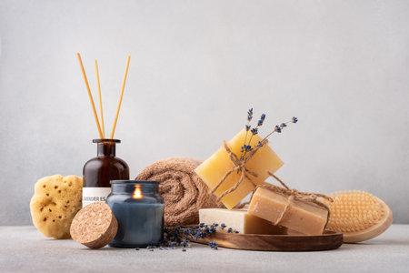 Cozy spa still life with handcrafted organic soap bars, towel and aroma candles. Natural and zero waste bathroom and self care concept.の写真素材