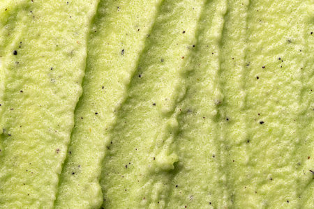 Sugar or salt green body scrub texture. Green scrub - skin care product with fruit extract as...