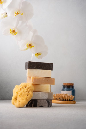 Stack of handcrafted soap bars and natural sponge. Natural, organic cleaning or skincare and...
