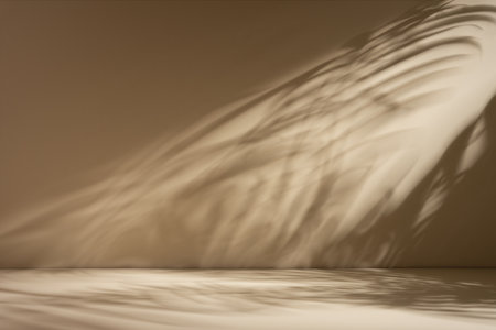 Minimal abstract beige background for product presentation with soft shadow and light from palm leaves on beige wall.の写真素材