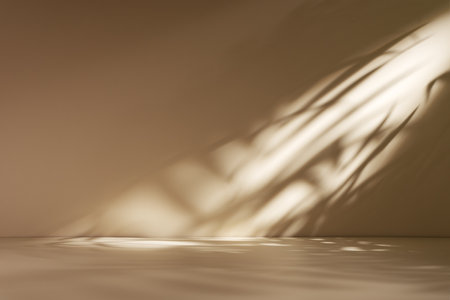 Minimal abstract beige background for product presentation with soft shadow and light from palm leaves on beige wall.の写真素材