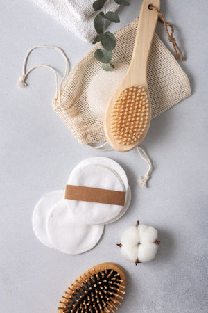 Eco friendly body care concept. Wooden brushes and a reusable cotton pads for self care.の写真素材