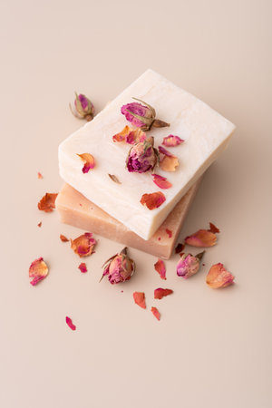 Handmade natural soap bars with dried rose petals on a beige background. Perfect for wellness, spa, organic skincare, aromatherapy, and romantic beauty concepts.の写真素材