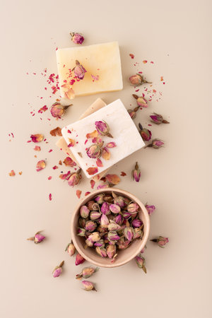 Handmade natural soap bars with dried rose petals on a beige background. Perfect for wellness, spa, organic skincare, aromatherapy, and romantic beauty concepts.の写真素材