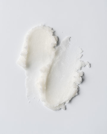 Closeup of solid white coconut oil with rich, creamy texture on white background. Natural organic skincare or culinary ingredient. Ideal for wellness, beauty, and cosmetic product design.の写真素材