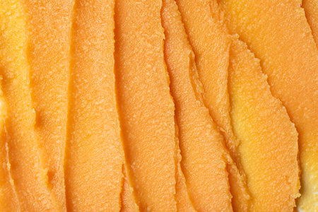 Closeup texture of raw Shea Butter with mango oil. Smooth, creamy consistency ideal for skincare, cosmetics, and natural wellness products. Vibrant organic texture perfect for backgrounds or product visuals.の写真素材