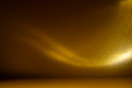 Golden background with soft sunlight and caustic light patterns. Abstract, glowing texture perfect for luxury, design, and festive themes.の写真素材
