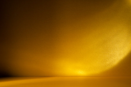 Golden background with soft sunlight and caustic light patterns. Abstract, glowing texture perfect for luxury, design, and festive themes.の写真素材