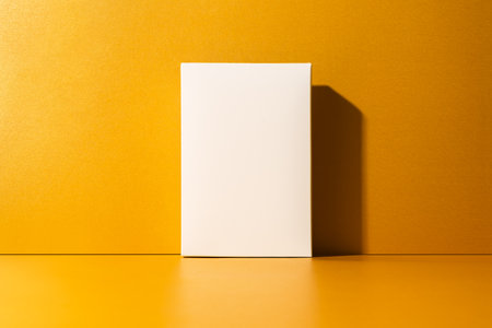 Minimalist white box on golden, yellow background with clean shadows. Perfect mockup for branding, packaging design, product display.の写真素材