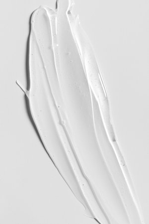 Transparent cosmetic gel texture on neutral background. Minimal beauty concept symbolizing clarity, purity and modern skincare aesthetics.の写真素材