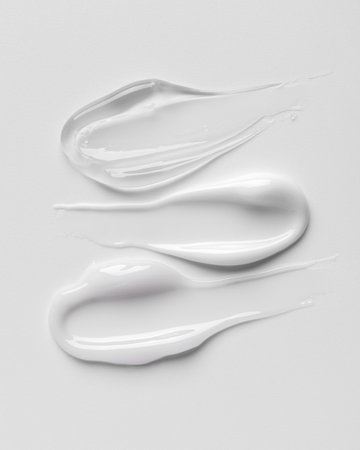 White cosmetic cream texture on clean background. Minimal skincare concept symbolizing softness, hydration, purity, and modern beauty product design for selfcare and wellness.の写真素材