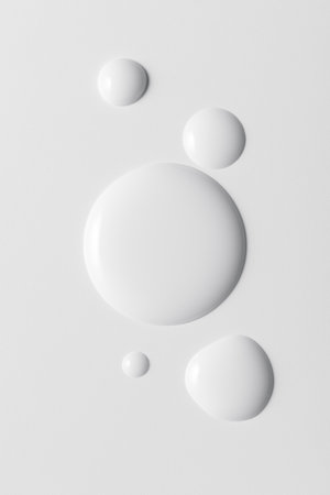 White cosmeticâs product drops on white background. Clean minimal beauty texture concept symbolizing purity, hydration and modern cosmetic design.の写真素材