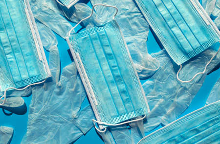 Surgical disposable face masks and latex gloves. Top view. Background made of many medical blue...
