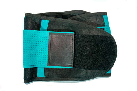 Close up of black medical waist belt for back pain isolated on white background. Top view.