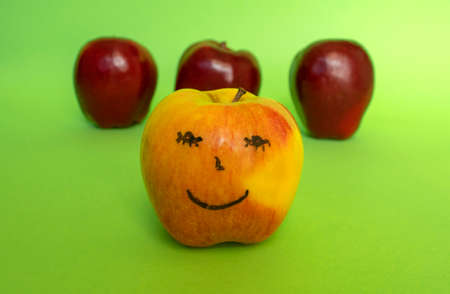 Happy smiling apple face on green background.の写真素材
