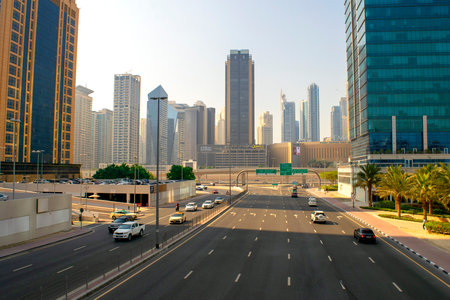 Dubai / UAE - October 21, 2019: Top view of JLT road looking on Dubai Marina. Traffic on highway. Big intersection and metro line ahead.のeditorial素材