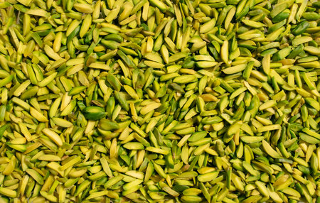 Background made of pistachios nuts. Healthy snack and food. Top view. Nuts. Pista sticks backdrop
