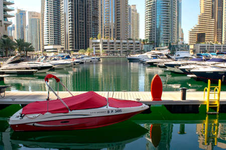 Dubai / UAE - November 11, 2019: Dubai Marina district with beautiful skyscrapers and yachts. Dubai Marina yachts parking with wooden pier.のeditorial素材
