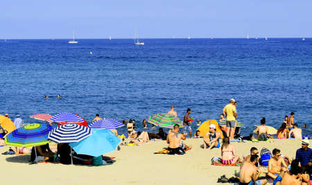 Barcelona / Spain - July 13,2019: Famous public La Barceloneta beach with many people. Barcelona...