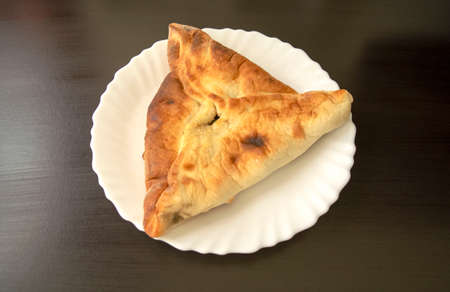 Famous traditional Arabic, Middle East, Israel cuisine. Spinach Manakish on dark wooden background....