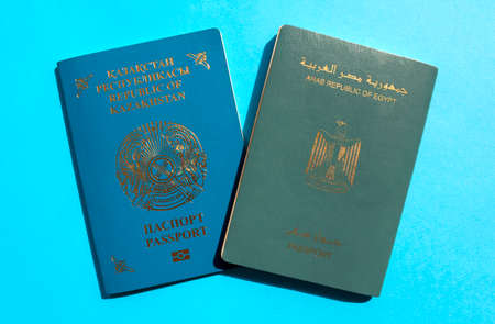 Dubai / UAE - June 10, 2020: Kazakhstan and Egypt passports on blue background. Two international passports of different countiesのeditorial素材