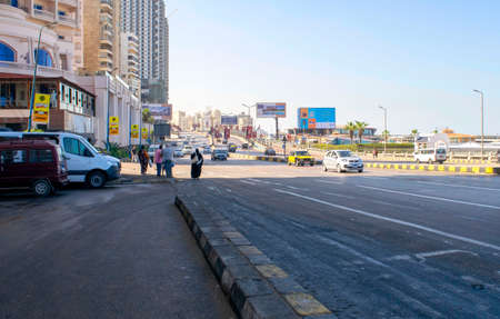 Main street of Alexandria touristic city. Corniche Avenue with hotels, car traffic, and residential buildingsのeditorial素材
