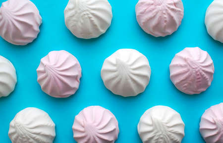 Background made of white and pink zephyr. Popular Russian dessert Zefir pattern.