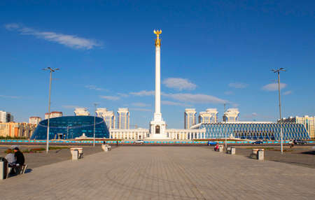 Kazakh Eli Monument with Independence square, Kazakh National University of the Arts, Palace of Independence on Tauelsizdik avenue during a day on the bright blue sky background, summer time.のeditorial素材