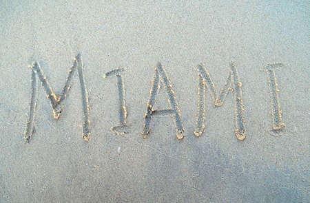 Miami word is written on a beach sand. Miami city inscription on a sand. USA