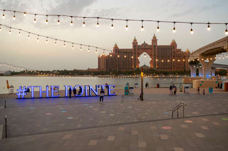 The Pointe sign in a square with the view on Atlantis, The Palm hotel before the sunset. Tiled...