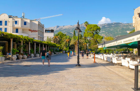Montenegro - Budva: September 8, 2021: Old town of Budva main square. Heritage site with the ancient town of Budva defense wall with street cafesのeditorial素材
