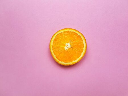 Slices of juicy orange on a bright pink background. High quality photoの写真素材