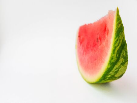Bright juicy red watermelon cut into slices on a white background. Space for text. High quality photoの写真素材